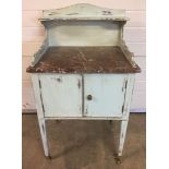 A shabby chic painted vintage marble top wash stand with brass castor feet, 61cm wide, 102cm high