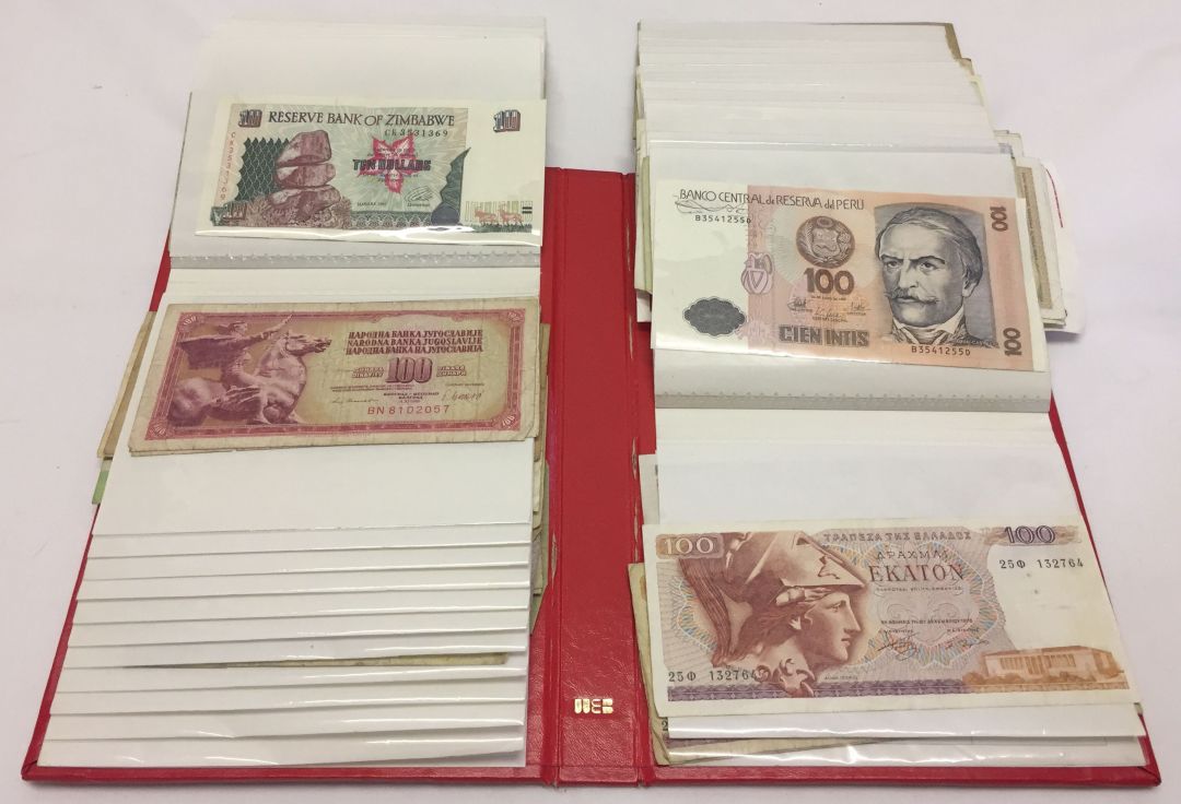 Photo album contaning various world banknotes.