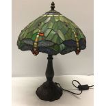 A Tiffany style lamp with dragonfly design lampshade.