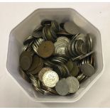 A tub containing world coins.