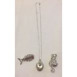 2 silver brooches: a cat and a fish together with a silver locket on a chain.