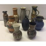 A quantity of studio pottery jugs and vases to include Denby and Langley.