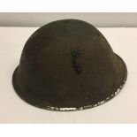 A military tin helmet with leather liner.