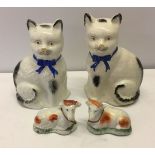 A pair of Staffordshire ceramic cows together with a pair of vintage ceramic cats - paintwork