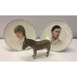 A pair of Royal Albert plates depicting Charles and Diana together with a brown Beswick donkey.