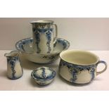 A Victorian ceramic bathroom set with blue floral pattern comprising: jug and bowl, chamber pot,