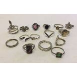 A collection of 15 silver rings of various sizes and designs.