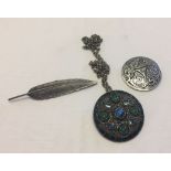 3 items of costume jewellery comprising St. Justin brooch, a feather brooch and a Miracle