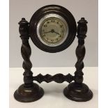 A c1930s mantle clock on barley twist support. In working order.