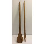 Large decorative African wood spoon and fork measuring approx 94cm long.