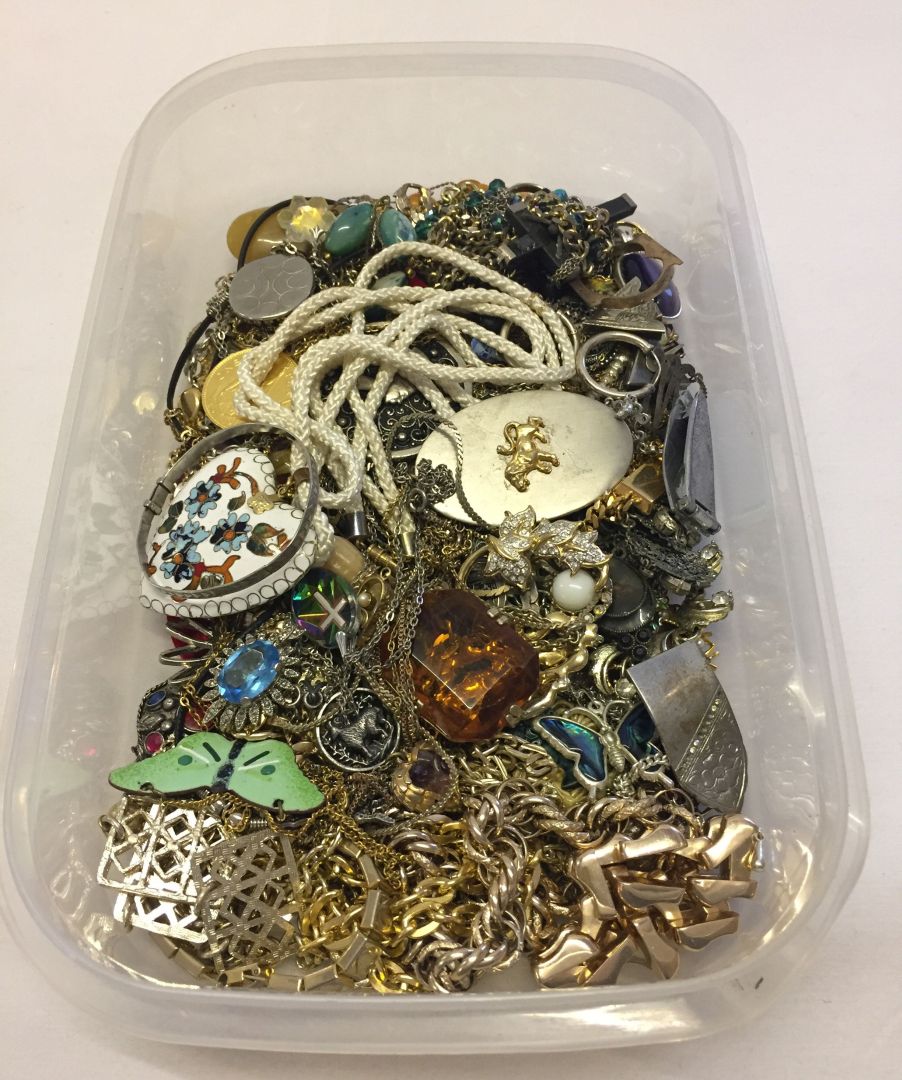 A plastic tray of costume jewellery pendants and chains to include enamelled pendants.