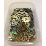 A plastic tray of costume jewellery pendants and chains to include enamelled pendants.