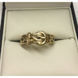 A gents ring in the shape of a buckle. Size W, approx weight vendor tested as 9ct gold.