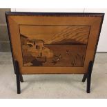 A vintage wooden firescreen with marquetry design to front.