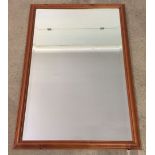 A large modern pine framed mirror. Approx 69 x 99cm.