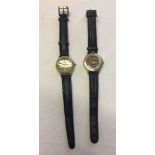 2 Harley Davidson wrist watches, both with leather straps.