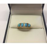 Edwardian ladies ring in 18ct gold, set with 4 oval turquoise stones with small diamonds between.