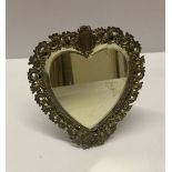 A vintage heart shaped white metal mirrors freestanding with 'Louie' engraved in cartouche. 19cm