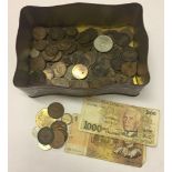 A tin of old english pennies together with foreign notes.