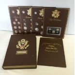 Kennedy Mint presentation case of American coins. Includes: 1) Lincoln memorial collection of cents.