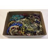 A box with a large quantity of old and new costume jewellery including diamante and glass beads.