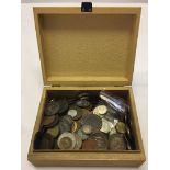 A fawn box containing world coins.