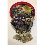 A round tub with a large amount of modern and vintage costume jewellery including faux pearl,