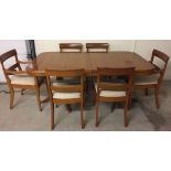 A modern light wood extending table and 6 chairs (to include 2 carvers).