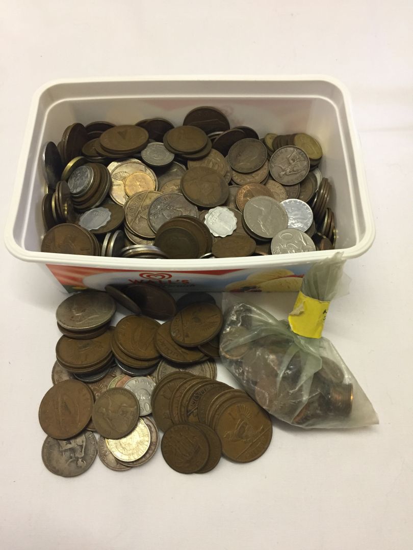 A tub containing various world coins.