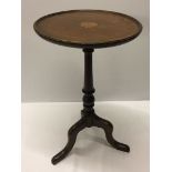 A tripod wine table with inlaid top.