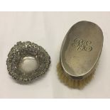 A silver backed clothes brush hallmarked Chester 1920 together with a decorative silver pin dish