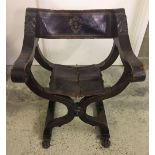 A vintage throne style chair with leather seat (seat in need of repair).