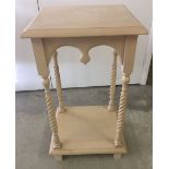 A cream painted barley twist side table. 81cm tall.