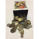 A small tin containing various world coins.