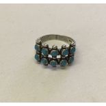 Sterling silver dress ring set with 10 turquoise stones. Size Q.