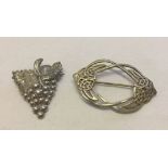 2 vintage silver brooches, one an Art Nouveau design and the other a bunch of grapes on the vine.
