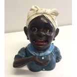 A reproduction cast iron money box of a black lady.