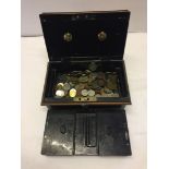 A large money tin with compartment tray containing world coins.