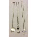 3 contemporary style silver pendants on silver chains including a cross design set with a crystal (