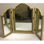 A vintage cream and gilt triple dressing table mirror. Approx 64cm high.