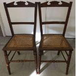 A pair of Edwardian cane seated bedroom chairs.