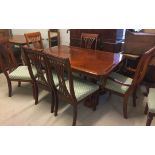 A cherry coloured extending dining table together with 5 chairs and 2 carvers.