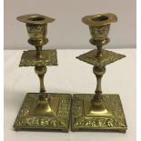 A pair of decorative brass candlesticks.