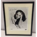 A framed and glazed signed black & white photo of Sade with Epic Records logo. Image size approx