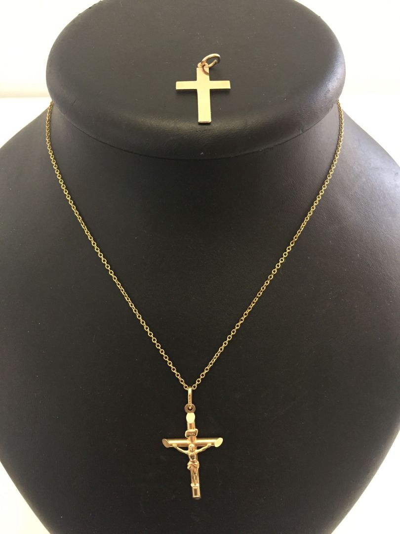 A 9ct gold crucifix measuring 4cm long (to the top of the bale) together with a 9ct gold cross and a