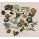 A quantiy of costume jewellery brooches to include butterflies and animal themes brooches.