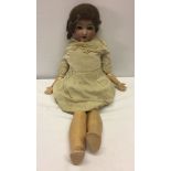 A Simon & Halbig German bisque head doll. 1909 size 6 head. 23" tall.