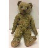 A c1910 German teddy bear, possibly Steiff. Well loved golden mohair, straw filled, boot button