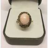 Ladies vintage silver gilt cocktail ring set with coral in an oval decorative mount. Size O