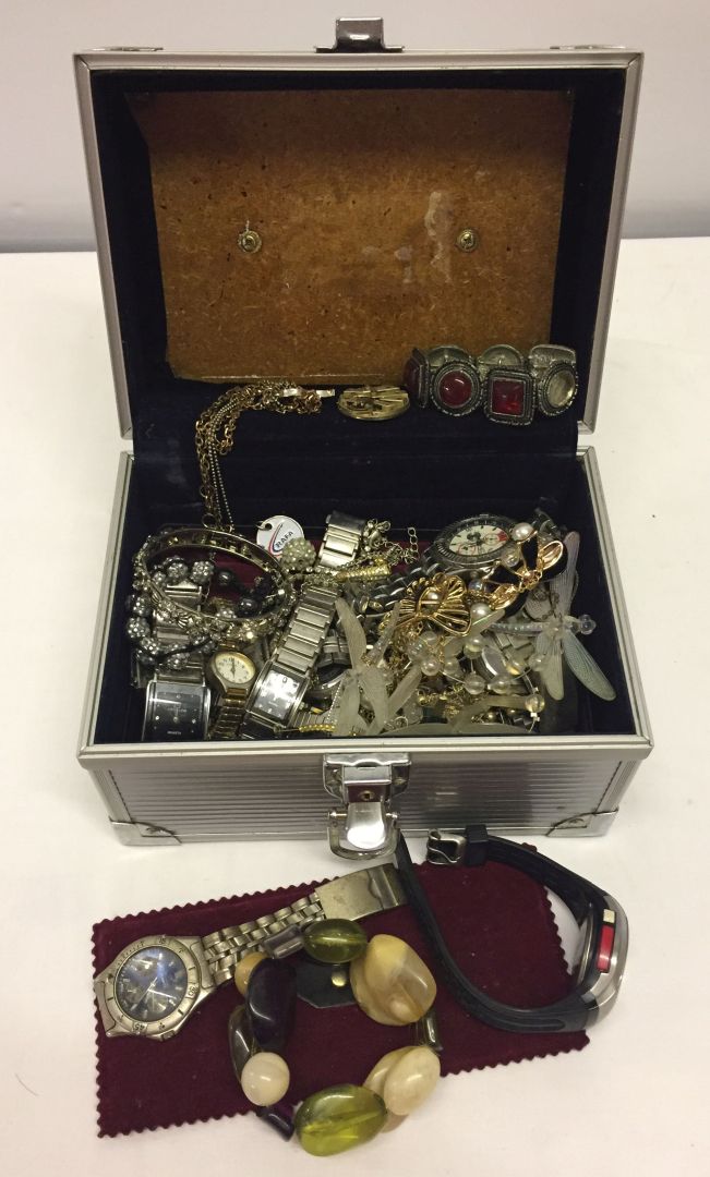 An aluminium jewellery carry case full of costume jewellery and ladies & gents watches.